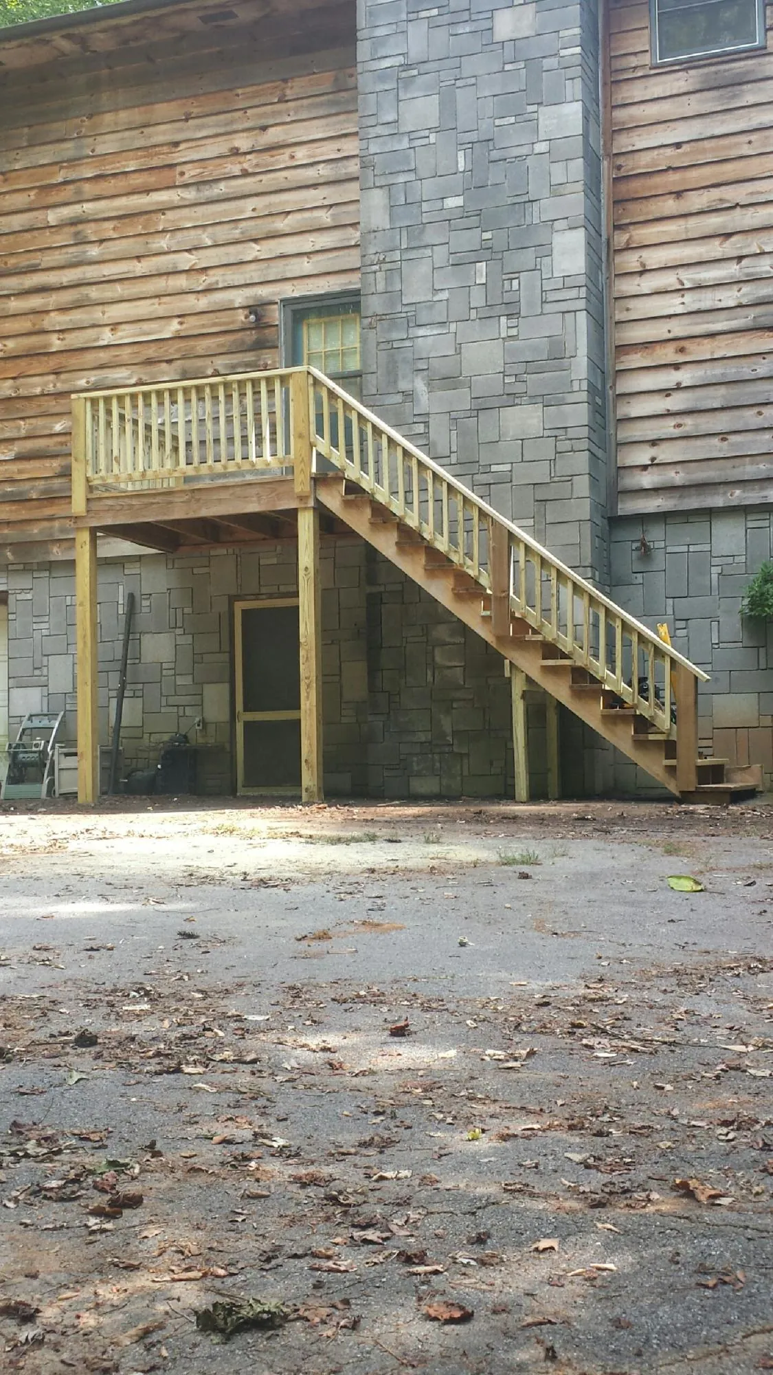 New pressure treated deck and stair landing on a log home in La Quinta